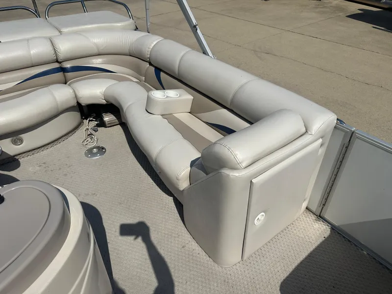 Slide: The Image of 2006 Crest Caribbean 250 boat interior with plush seating and cup holders. - 10