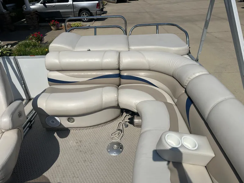 Slide: The Image of 2006 Crest Caribbean 250 boat interior with plush seating and cup holders. - 11