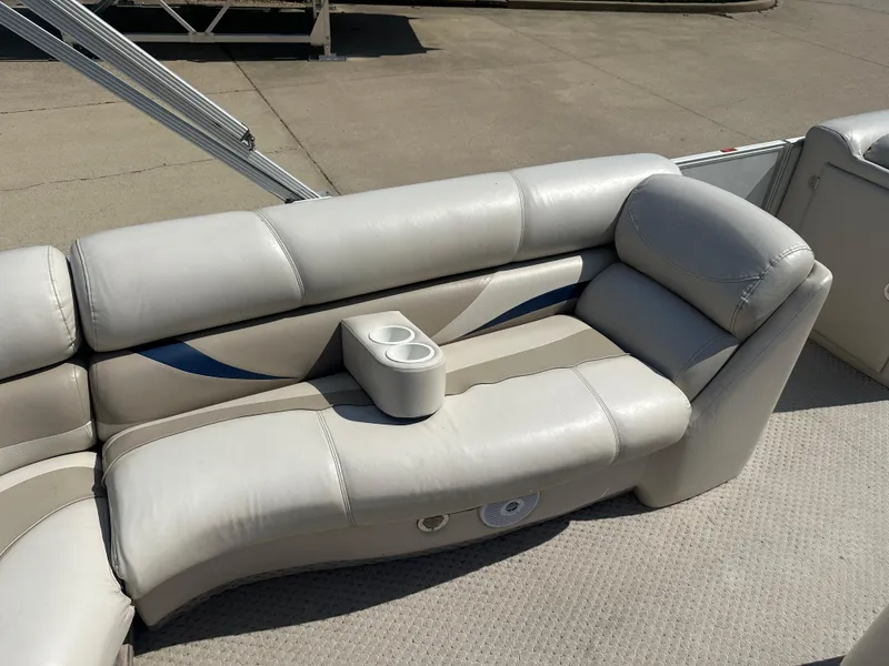 Slide: The Image of 2006 Crest Caribbean 250 boat interior with beige seating and cup holders. - 14