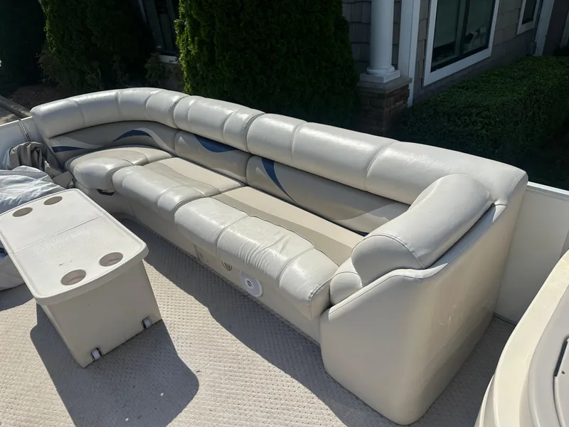 Slide: The Image of 2006 Crest Caribbean 250 boat interior with beige seating and table. - 15