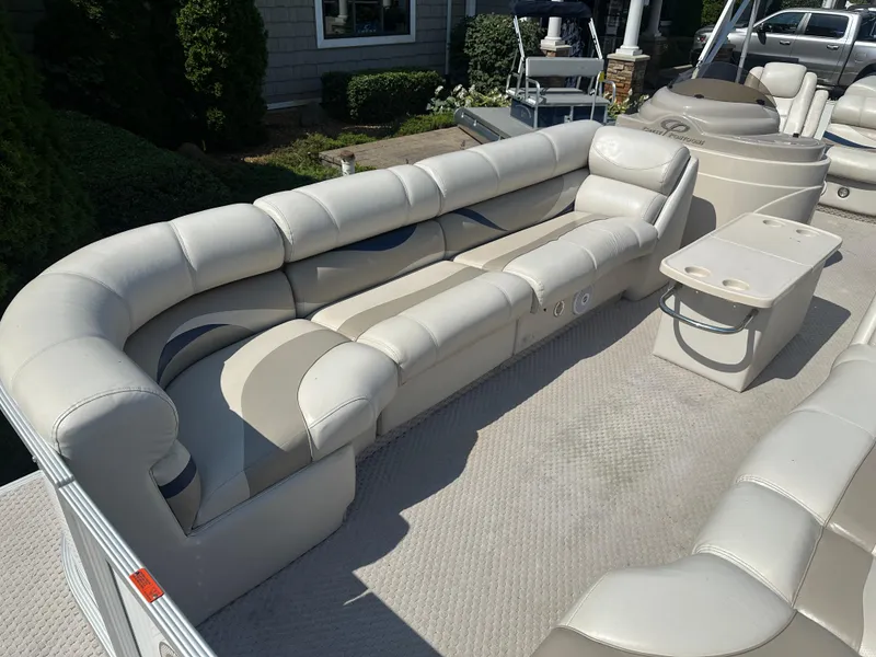 Slide: The Image of 2006 Crest Caribbean 250 pontoon boat with spacious seating and table on deck. - 5