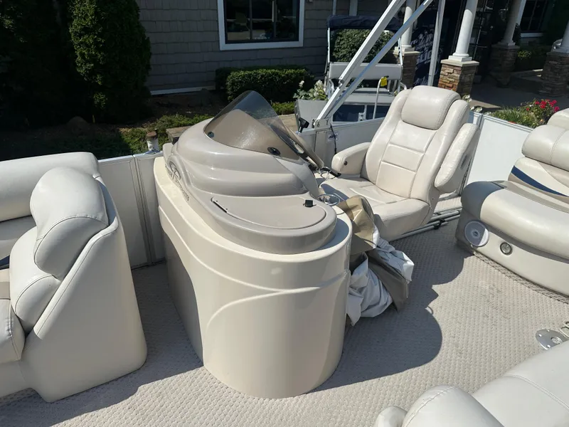 Slide: The Image of 2006 Crest Caribbean 250 boat interior with white seating and helm. - 6