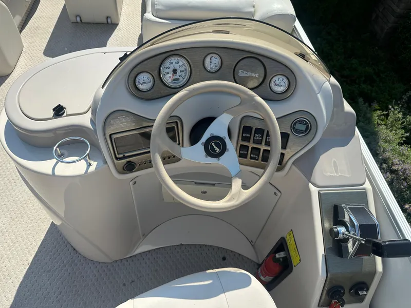 Slide: The Image of Steering console of a 2006 Crest Caribbean 250 boat with gauges and controls. - 7