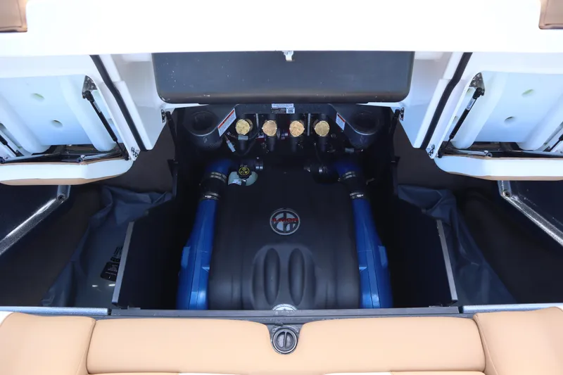 Slide: The Image of 2020 MasterCraft X24 engine compartment with blue accents and open storage hatches. - 22