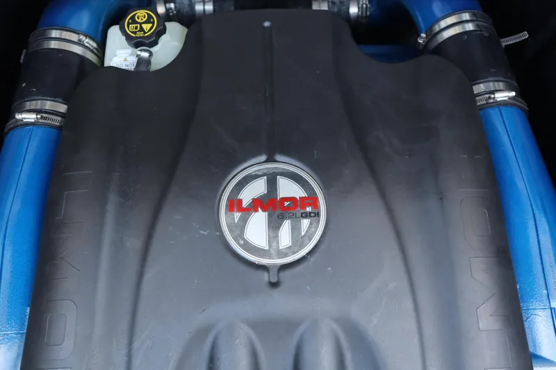 Slide: The Image of Engine cover of a 2020 MasterCraft X24 with Ilmor branding and blue hoses. - 23