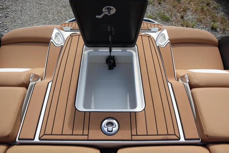 Slide: The Image of 2020 MasterCraft X24 boat with open storage compartment on teak deck. - 24