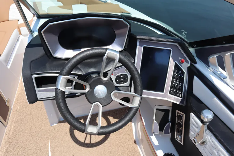 Slide: The Image of 2020 MasterCraft X24 boat dashboard with steering wheel and touchscreen controls. - 9