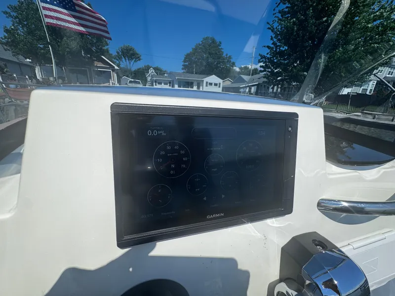 Slide: The Image of Dashboard of 2022 Brig Eagle 6 boat with Garmin display and American flag in background. - 23