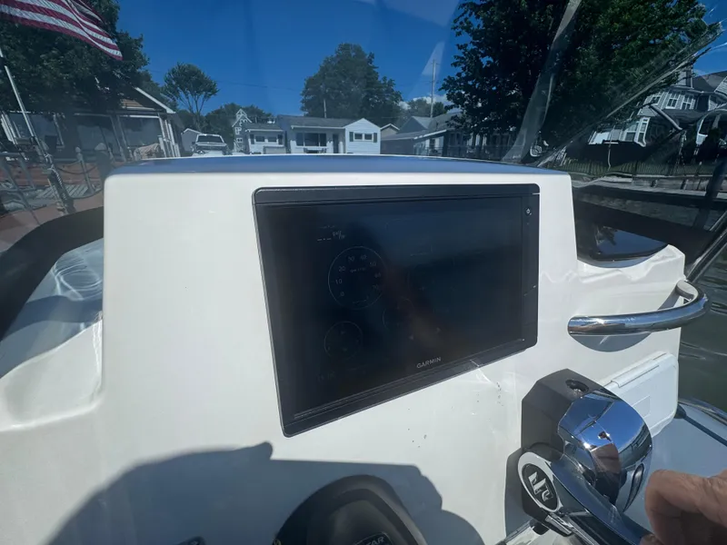 Slide: The Image of Control panel of 2022 Brig Eagle 6 boat with Garmin display and throttle lever. - 22