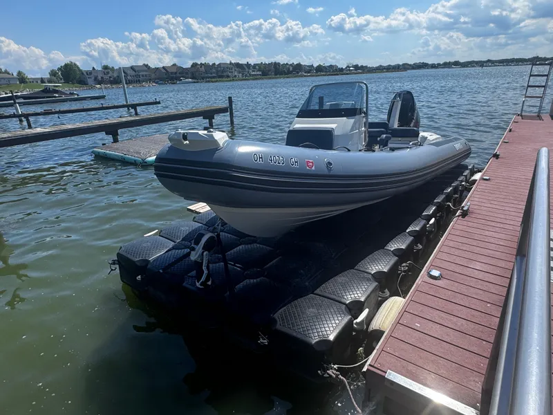 Slide: The Image of 2022 Brig Eagle 6 boat docked on a sunny lake with blue skies. - 7