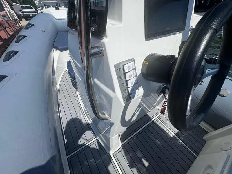 Slide: The Image of 2022 Brig Eagle 6 boat interior with steering wheel and control panel. - 21