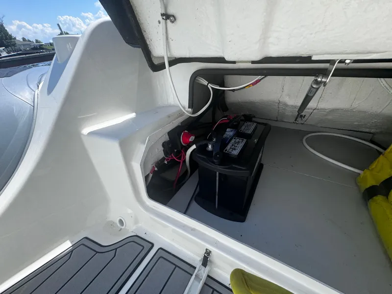 Slide: The Image of 2022 Brig Eagle 6 boat battery compartment with wiring and storage space. - 19