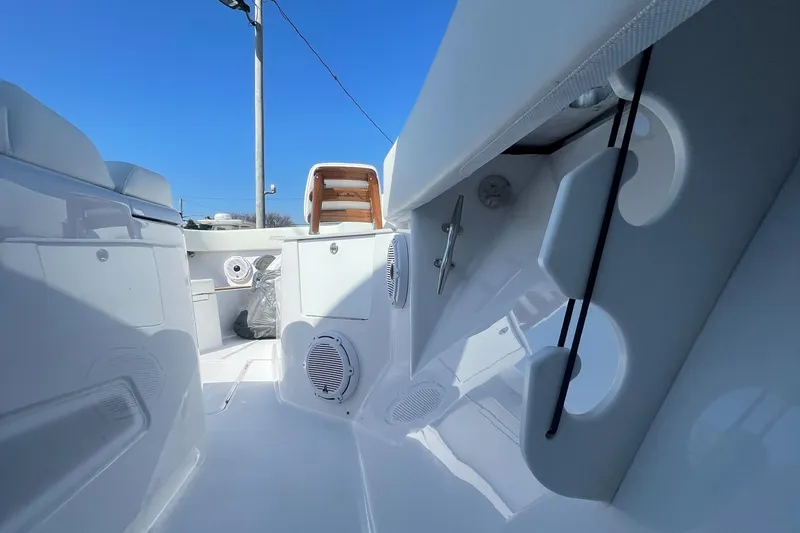 Slide: The Image of 2023 Jupiter 40 boat interior with white seating and storage compartments. - 16