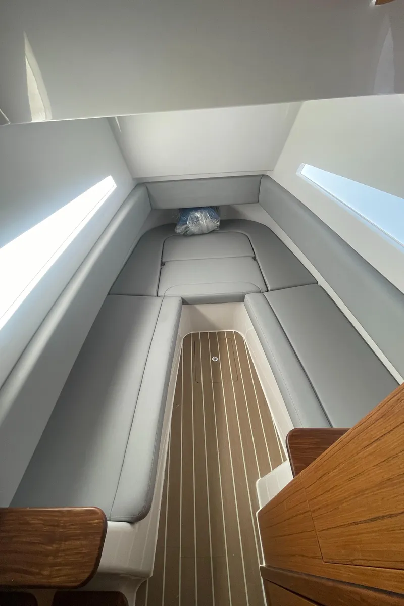 Slide: The Image of Interior cabin of 2023 Jupiter 40 boat with grey seating and wooden flooring. - 20