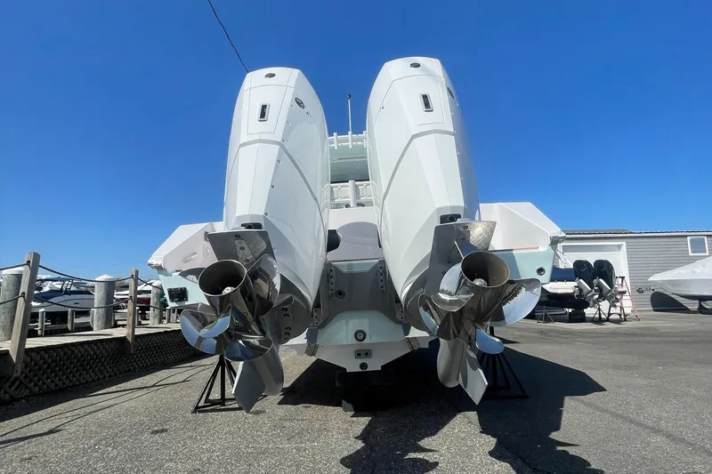 Slide: The Image of 2023 Jupiter 40 boat with dual outboard engines in a marina. - 25