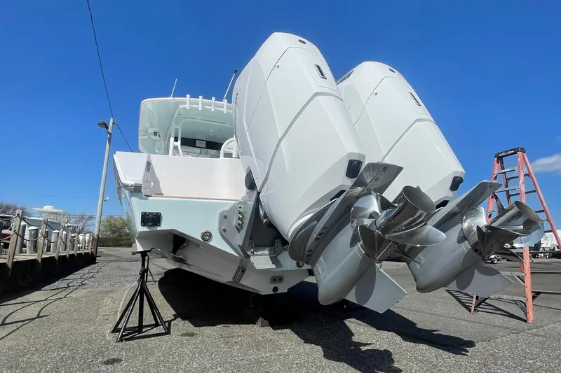 Slide: The Image of 2023 Jupiter 40 boat with dual outboard engines on a trailer. - 26