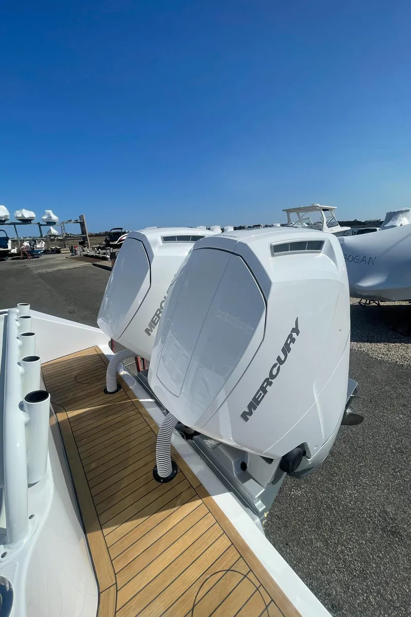 Slide: The Image of 2023 Jupiter 40 boat with twin Mercury outboard engines on a sunny day. - 27