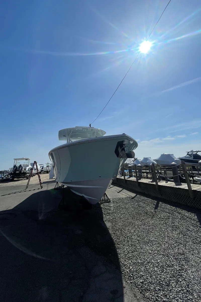 Slide: The Image of 2023 Jupiter 40 boat docked under a bright sun. - 6