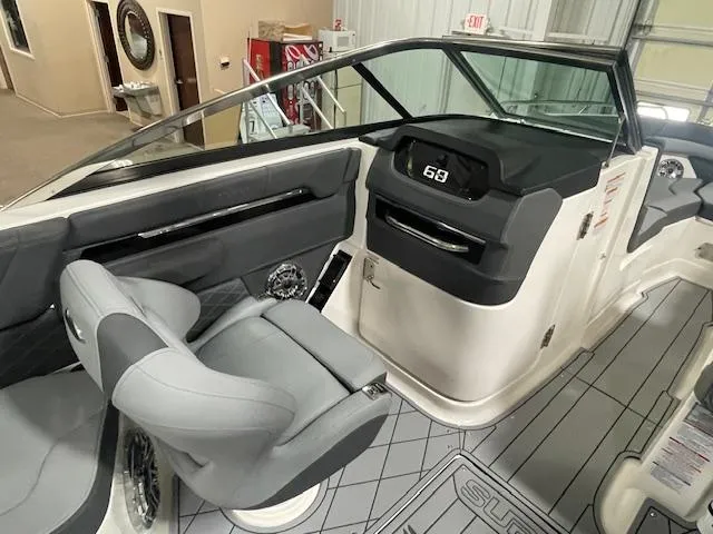 Slide: The Image of 2025 Chaparral 26 Surf boat interior with modern dashboard and seating. - 10