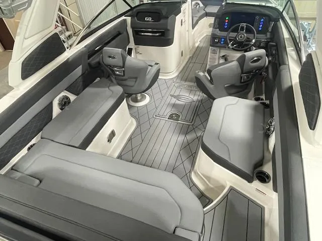 Slide: The Image of 2025 Chaparral 26 Surf boat interior with modern seating and dashboard controls. - 13