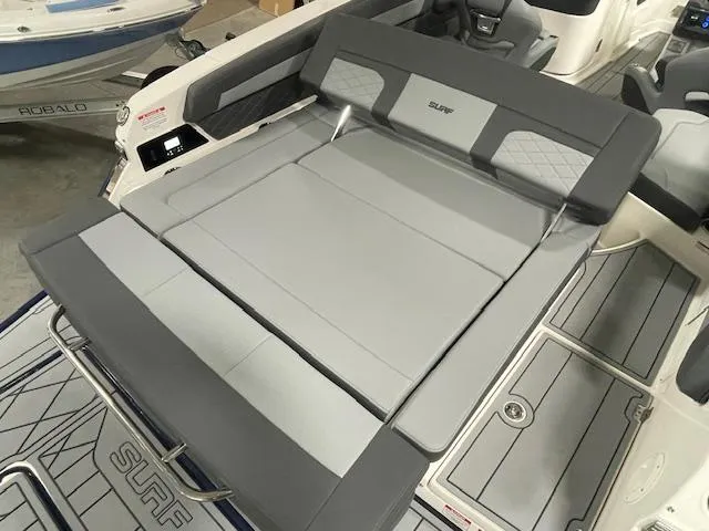 Slide: The Image of 2025 Chaparral 26 Surf boat interior with gray seating and deck. - 14