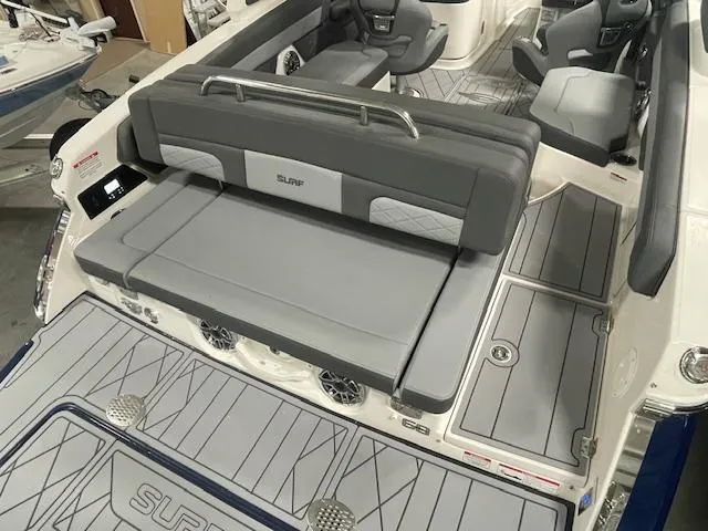 Slide: The Image of 2025 Chaparral 26 Surf boat interior with gray seating and deck. - 15