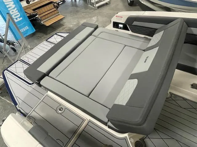 Slide: The Image of 2025 Chaparral 26 Surf boat with sleek gray seating and modern design. - 16