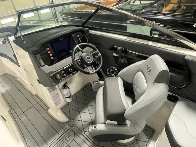 Slide: The Image of 2025 Chaparral 26 Surf boat interior with modern dashboard and comfortable seating. - 8