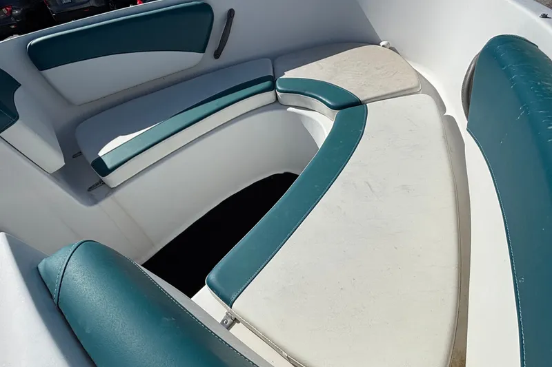 Slide: The Image of Interior seating of a 2001 Four Winns 180 Horizon boat with teal and white upholstery. - 6