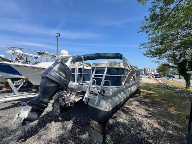 Slide: The Image of 2016 Godfrey 242 Premiere pontoon boat with Yamaha outboard motor, parked outdoors. - 11