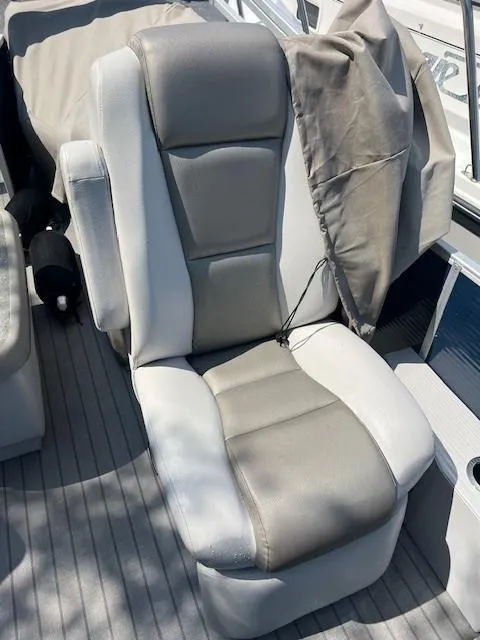 Slide: The Image of Captain's chair on 2016 Godfrey 242 Premiere boat, featuring gray and white upholstery. - 6