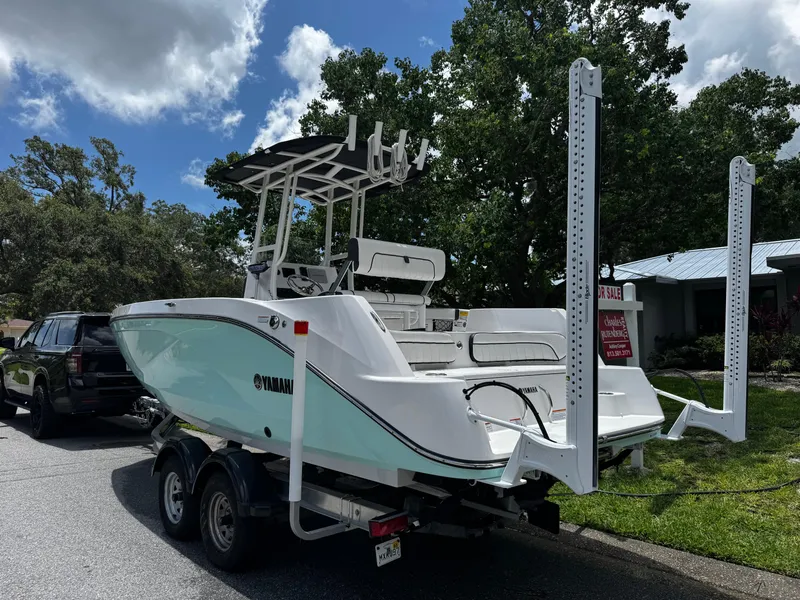Slide: The Image of 2023 Yamaha Boats 222 FSH Sport parked on street, for sale sign visible. - 3