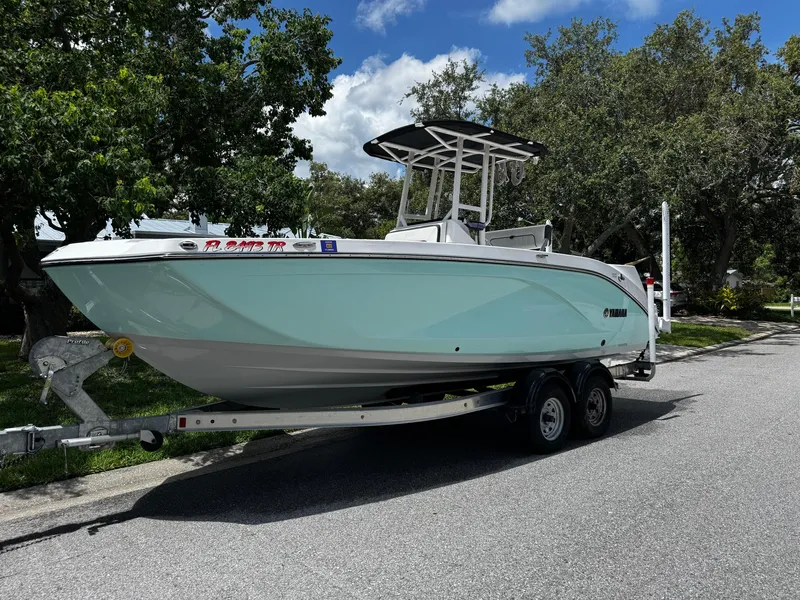 Slide: The Image of 2023 Yamaha Boats 222 FSH Sport engine compartment with high output engines and wiring. - 4