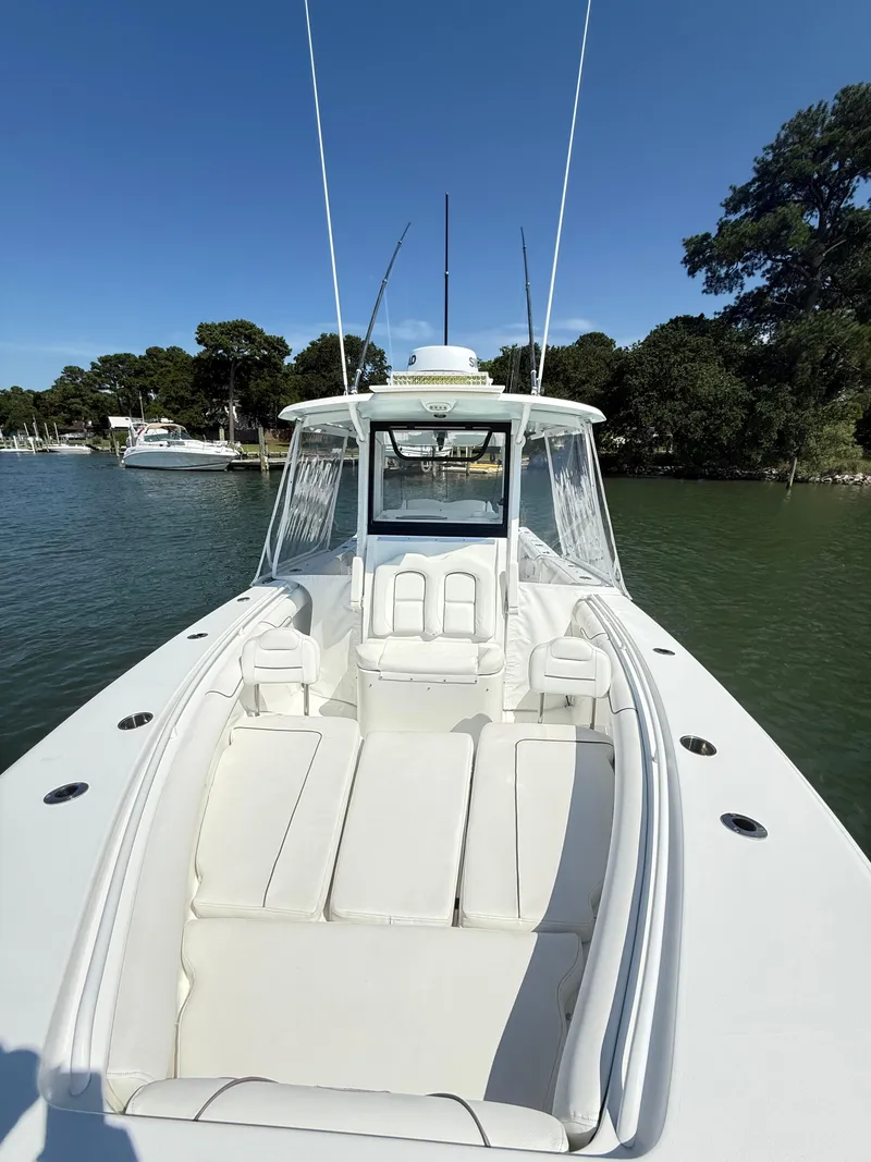 Slide: The Image of 2018 Sea Hunt Gamefish 30 boat with forward seating, docked on a sunny day. - 10