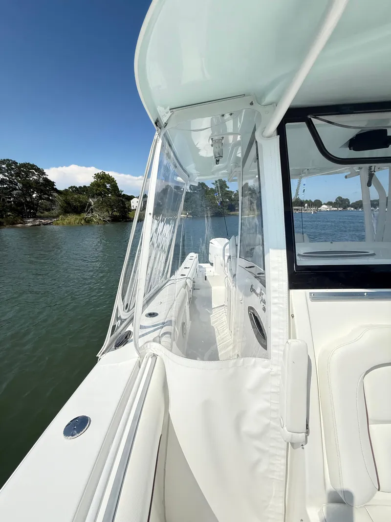 Slide: The Image of 2018 Sea Hunt Gamefish 30 boat with forward seating, docked on a sunny day. - 14