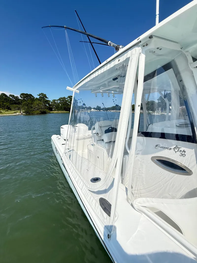 Slide: The Image of 2018 Sea Hunt Gamefish 30 boat with forward seating on calm water. - 15