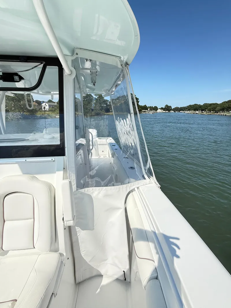 Slide: The Image of 2018 Sea Hunt Gamefish 30 boat with forward seating on a sunny day. - 16