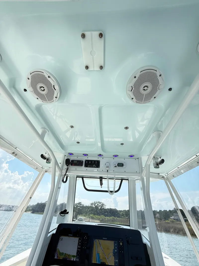 Slide: The Image of 2018 Sea Hunt Gamefish 30 boat interior with speakers and navigation equipment. - 21