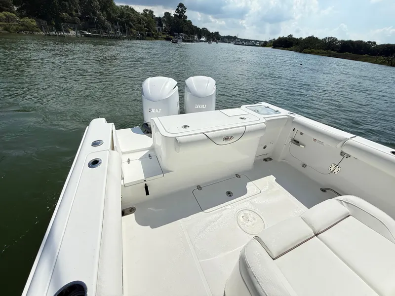 Slide: The Image of 2018 Sea Hunt Gamefish 30 boat with forward seating on a calm river. - 29