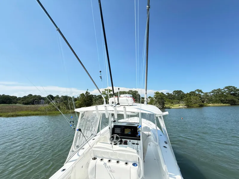Slide: The Image of 2018 Sea Hunt Gamefish 30 boat with forward seating on a calm lake. - 30