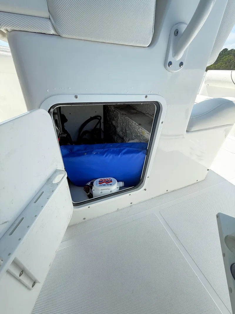 Slide: The Image of 2018 Sea Hunt Gamefish 30 storage compartment with blue equipment and white interior. - 33