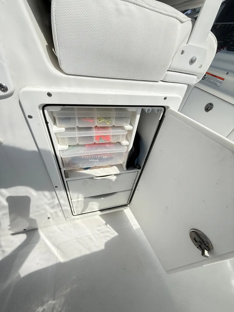 Slide: The Image of 2018 Sea Hunt Gamefish 30 storage compartment with organized tackle boxes. - 35