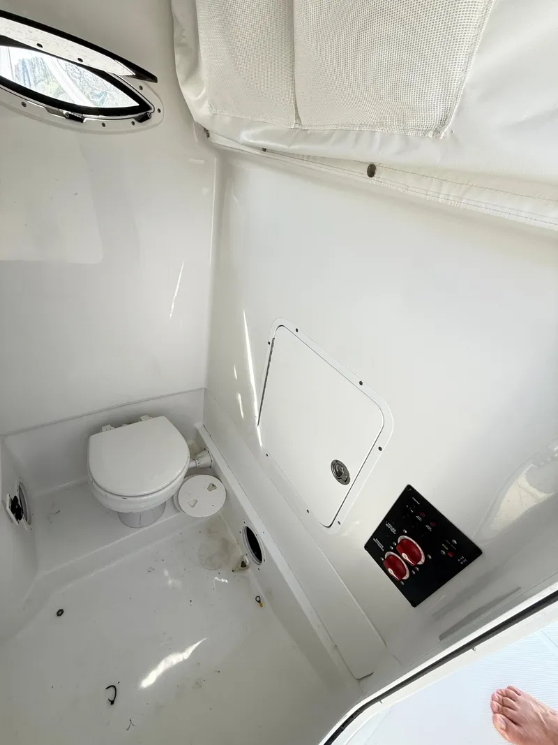 Slide: The Image of 2018 Sea Hunt Gamefish 30 boat interior with toilet and control panel. - 37