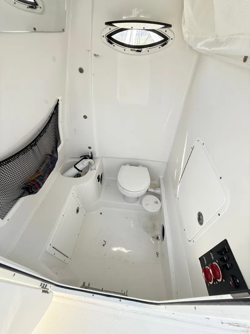 Slide: The Image of 2018 Sea Hunt Gamefish 30 boat interior with toilet and storage compartments. - 38