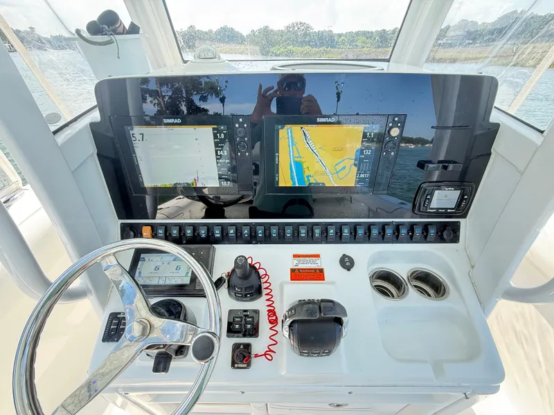 Slide: The Image of 2018 Sea Hunt Gamefish 30 dashboard with navigation screens and controls. - 6