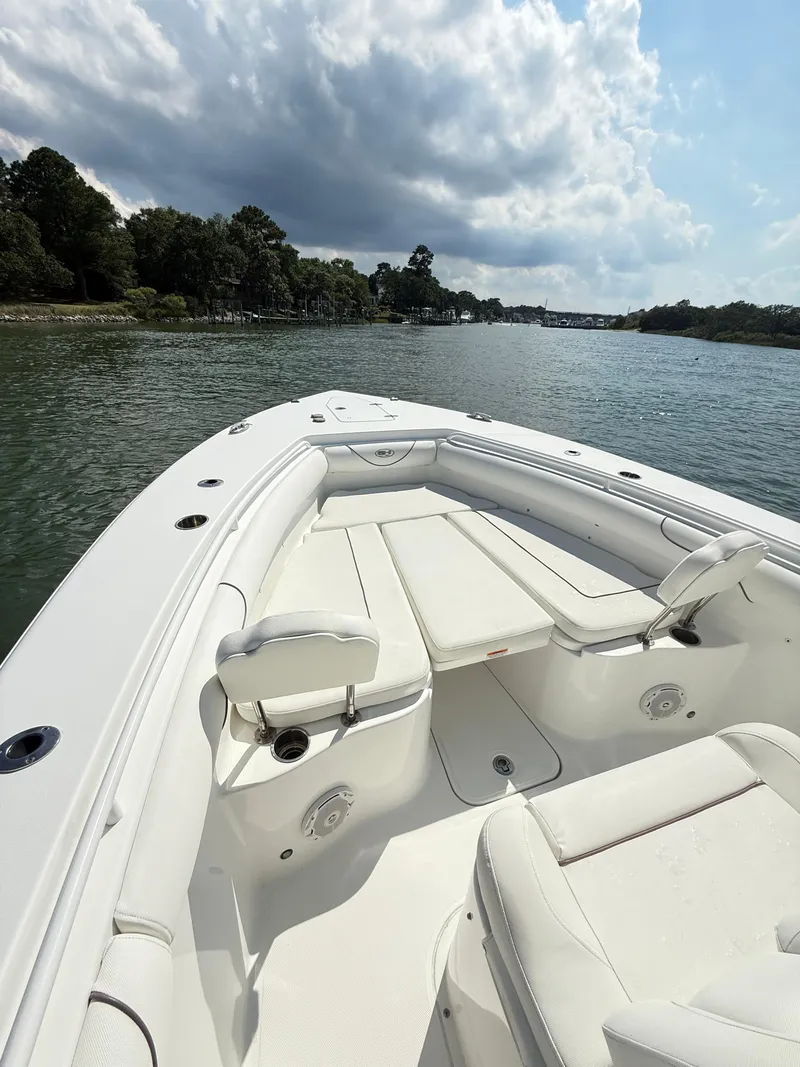 Slide: The Image of 2018 Sea Hunt Gamefish 30 boat with forward seating on a calm waterway. - 8