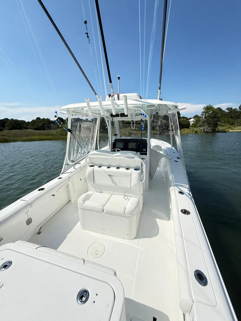 Slide: The Image of 2018 Sea Hunt Gamefish 30 boat with forward seating on calm water. - 9