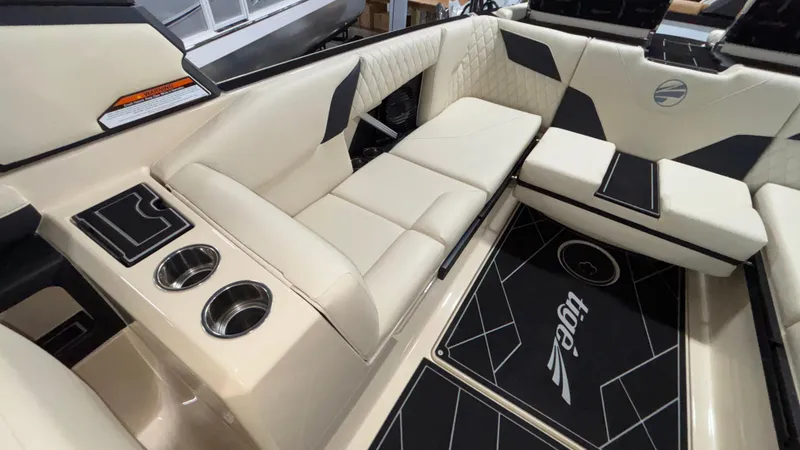 Slide: The Image of 2025 Tigé Z5 boat interior with beige seating, cup holders, and stylish black accents. - 12