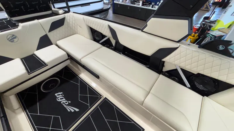 Slide: The Image of 2025 Tigé Z5 boat interior with beige seating and black accents. - 13