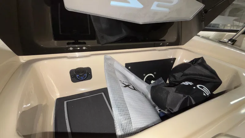 Slide: The Image of Storage compartment of 2025 Tigé Z5 boat with gear and accessories. - 15